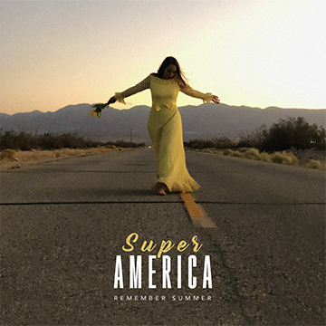 A woman in a yellow dress holding a flower walks in the middle of an empty road